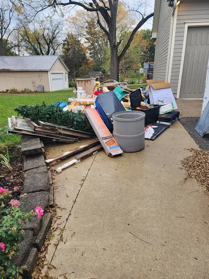 Dumpster being loaded with debris for Roofing Dumpster Rental in Bellevue